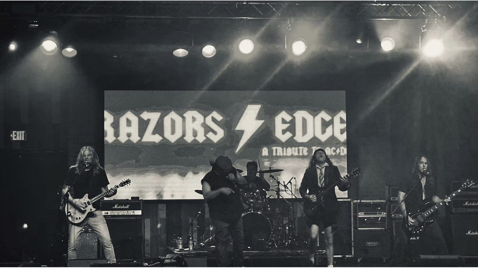 Razor's Edge performing live on stage โ crowd packed and energy through the roof
